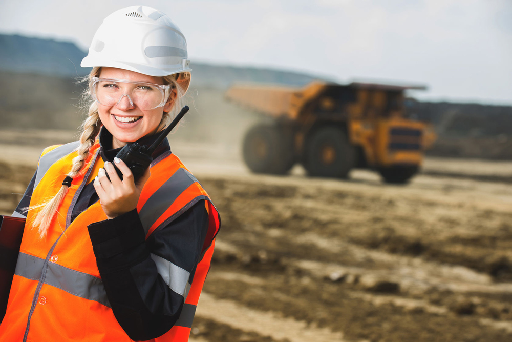 Young woman working on building site